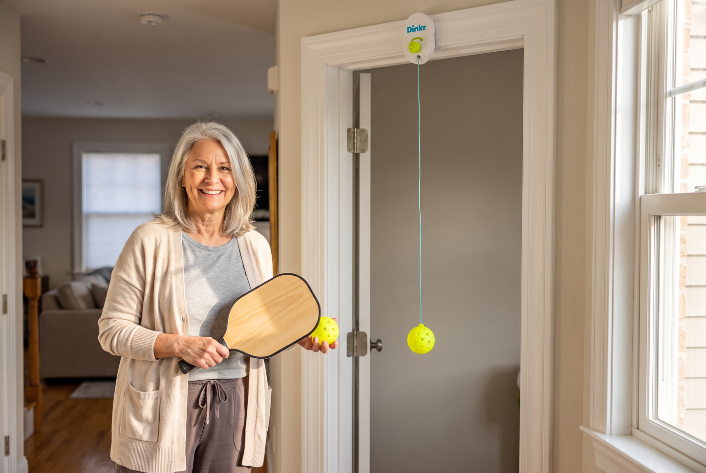 New pickleball player practicing at home with the Dink'r doorway trainer from the 30-Day Court-Ready Kit