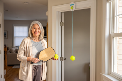 New pickleball player practicing at home with the Dink'r doorway trainer from the 30-Day Court-Ready Kit