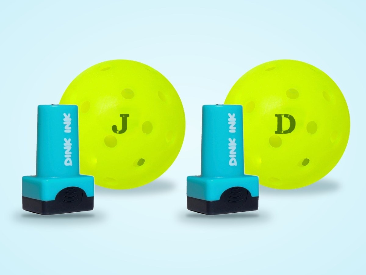 Two Dink Ink stampers, each beside a pickleball stamped with its letter