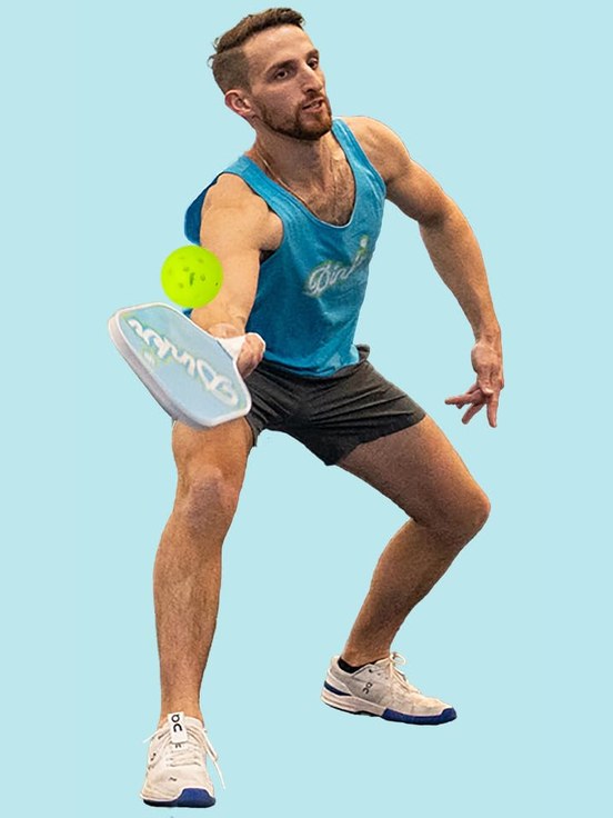 A pickleball player returning a ball